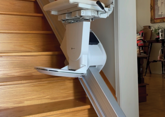 Handicare 1100 Stairlift moving up the stairs on steel railing