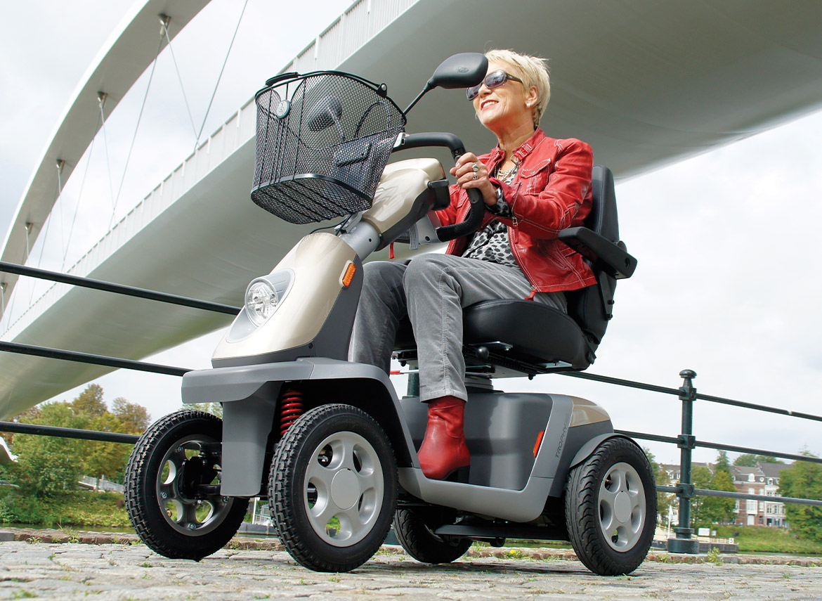 Lady driving a 4 wheel scooter
