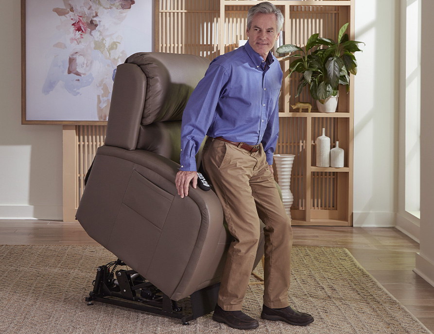 Recline chair being lifted in forward direction to help user stand