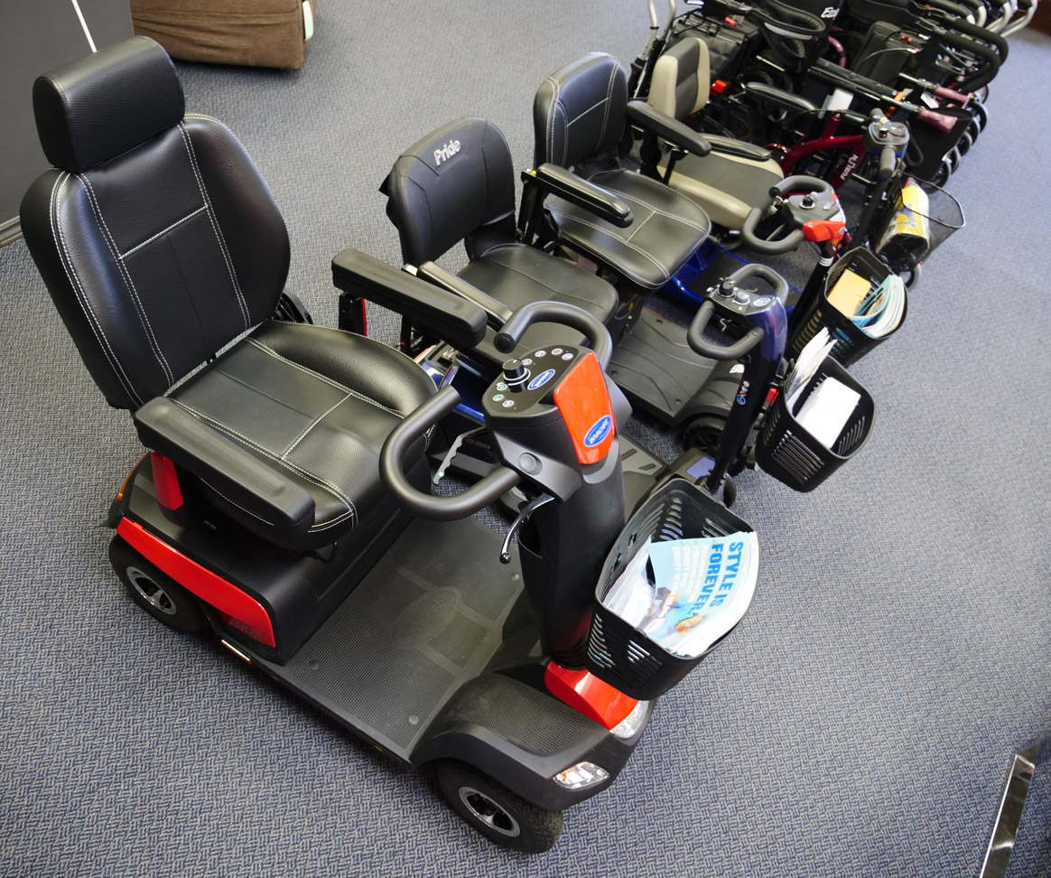 Row of mobility scooters in store with different seats