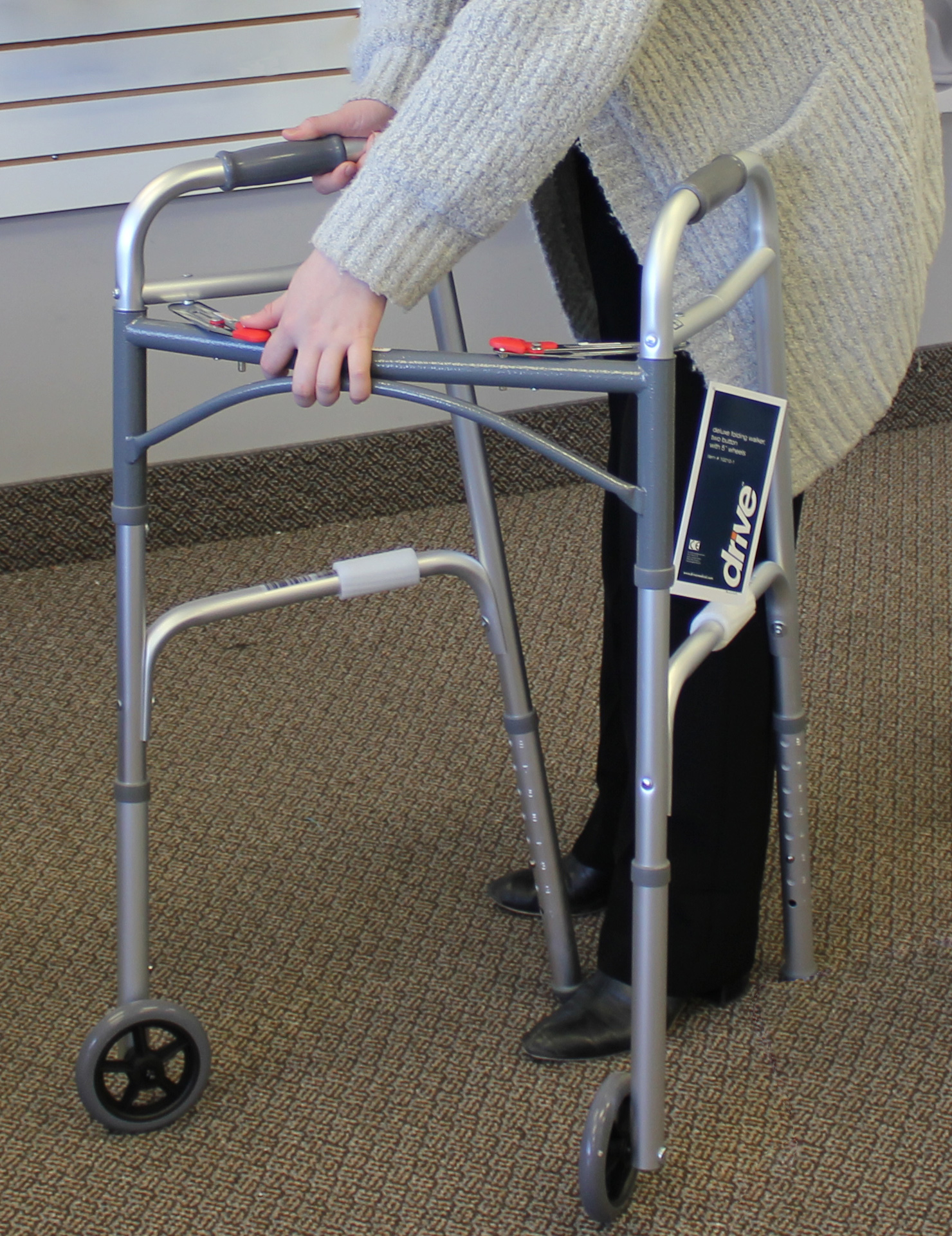 Person adjusting walker height