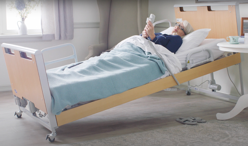 Woman in medical bed in Reverse Trendelenburg position