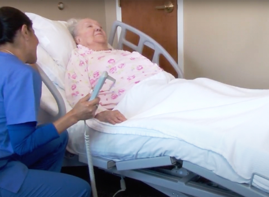 Patient in bed with nurse assistance