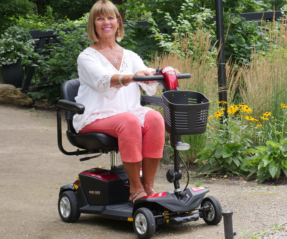 Person riding mobility scooter with a delta tiller