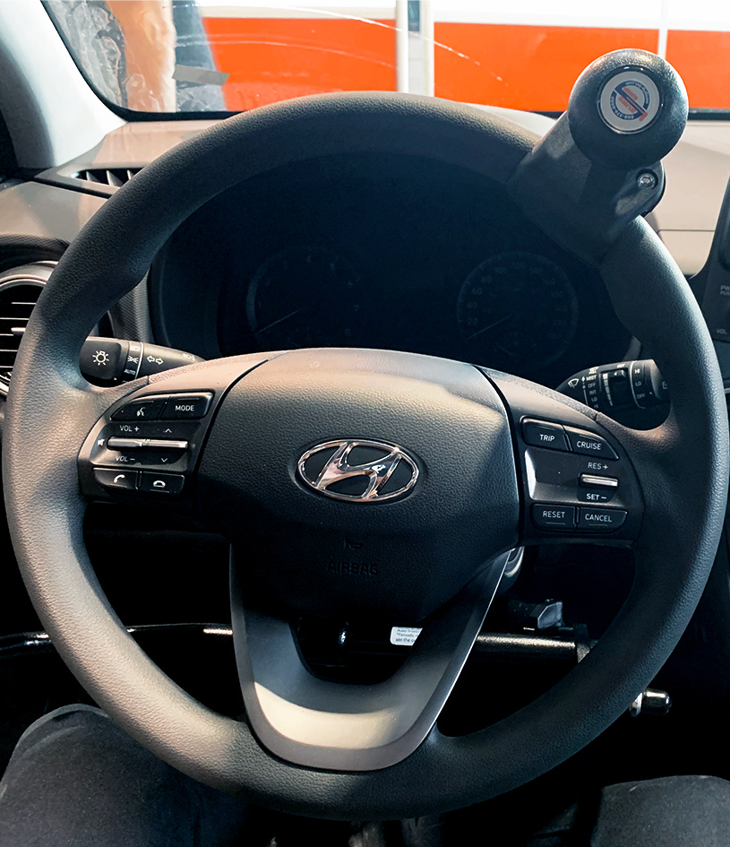 Hand control on a car steering wheel