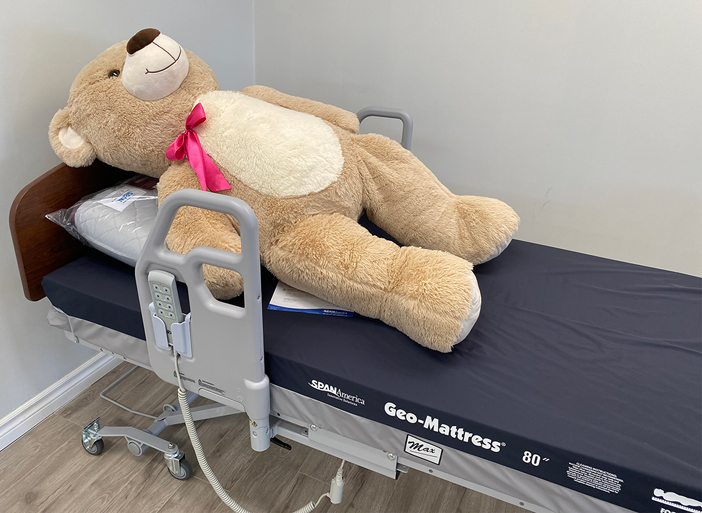 home hospital bed in store display with teddy bear