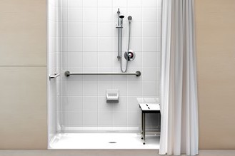 roll-in shower installation with hand rails and shower bench