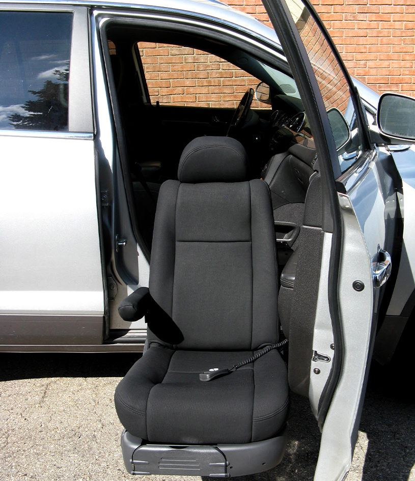 Passenger seat modified to turn 90 degree and lowered outside of accessible vehicle