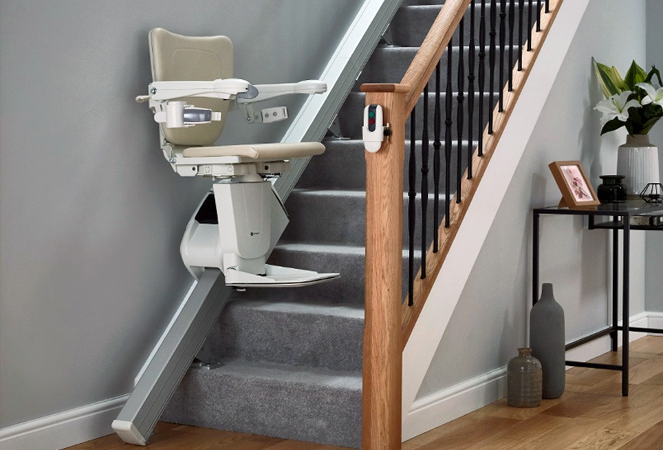 Straight stairlift with chair moving up the staircase